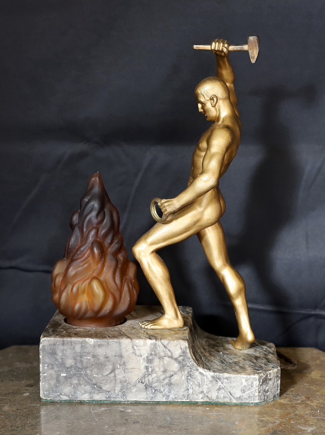 A 1930s Austrian bronzed spelter and marble lamp base modelled as Vulcan, stamped Bergman to the foot, height 32cm